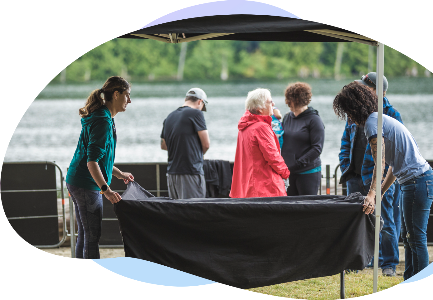 Two women setting up a registration tent