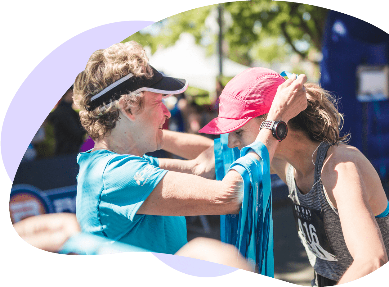 Event organizer putting a medal on a participant