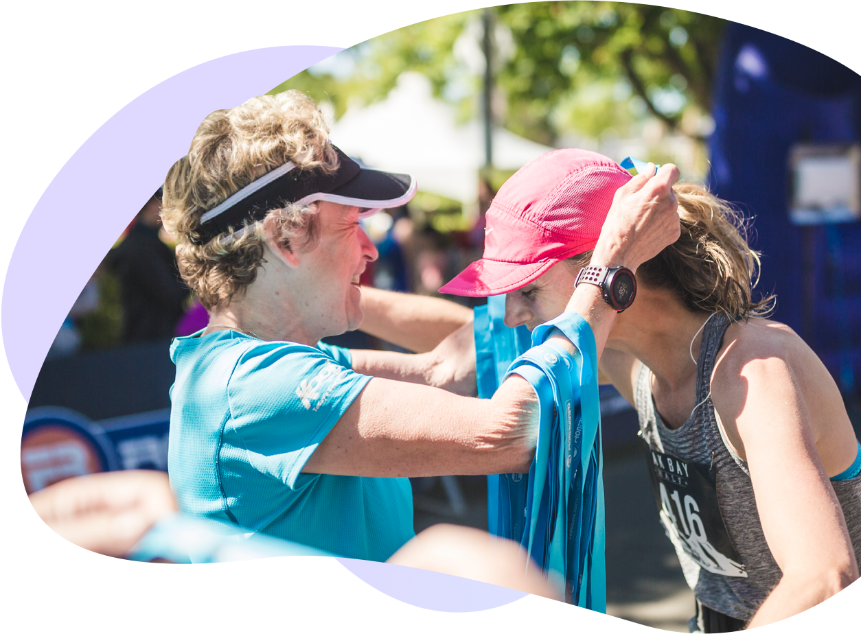 Event organizer placing a medal on a participant